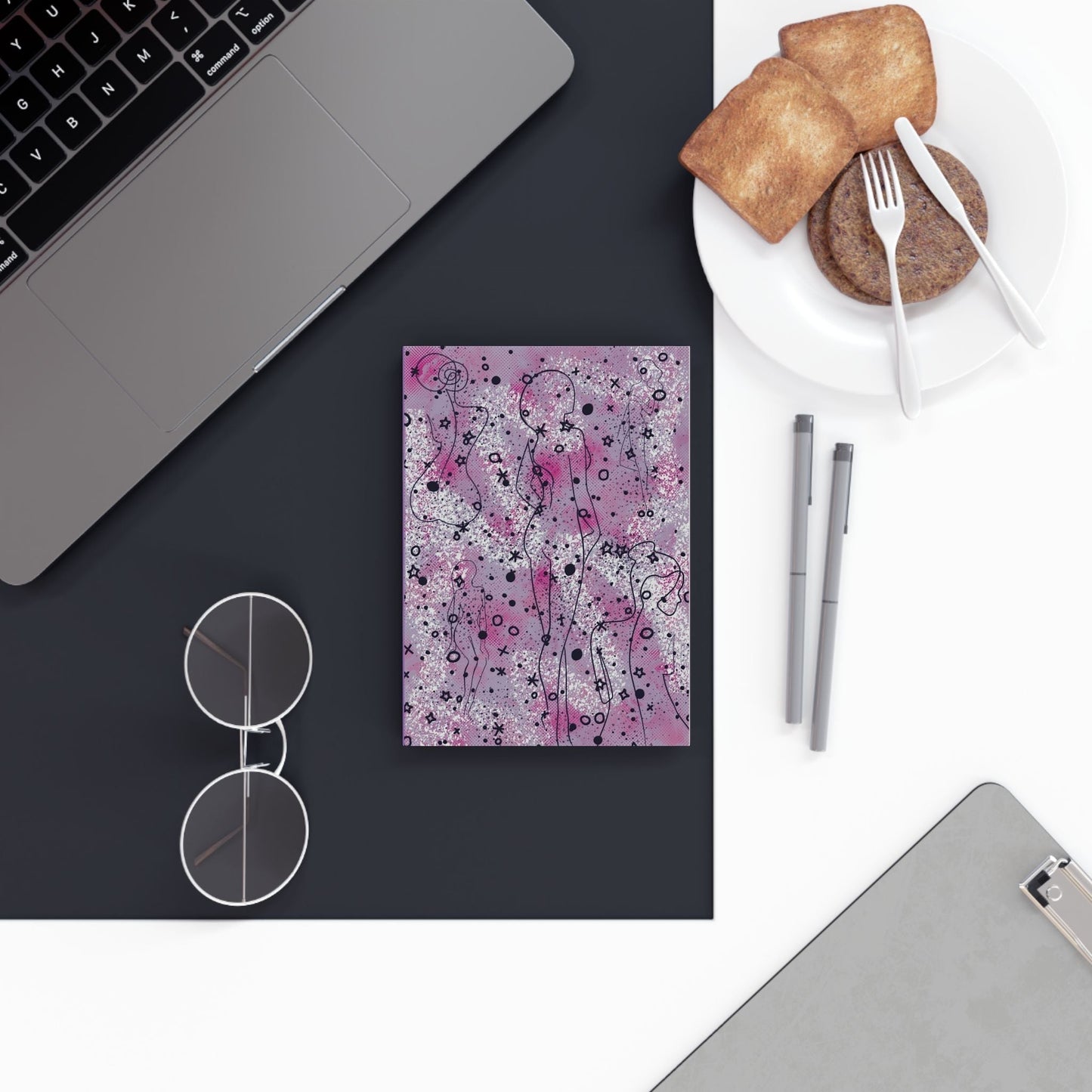 Whimsical A5 hardcover notebook with vibrant, eye-catching design on desk.
