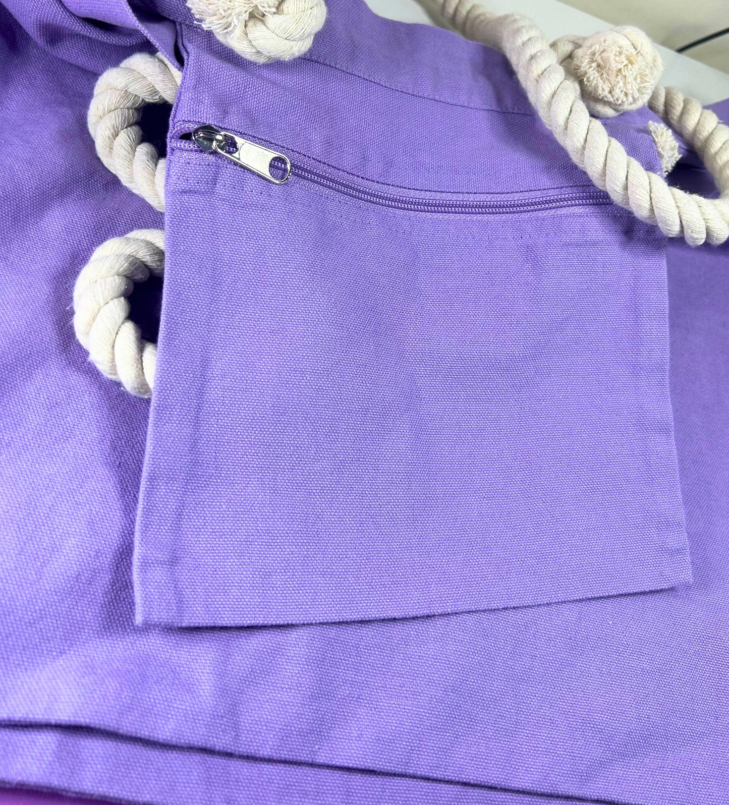 Lilac marine style tote bag with thick twisted rope handles and front zip pocket detail