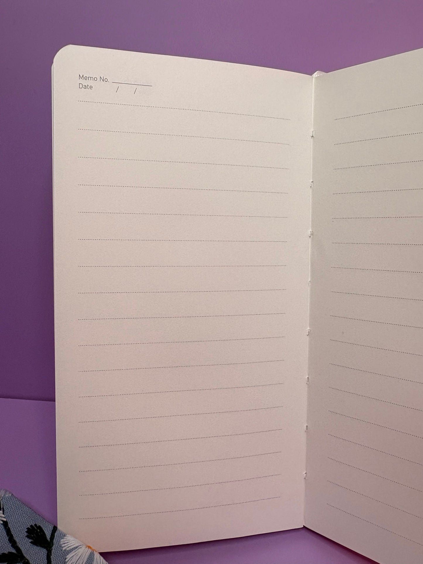 A6 Embroidered Daisy notebook open to lined pages with memo and date fields on purple background