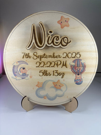 Personalised baby birth announcement plaque with 3D name, birth details, and cute illustrations on eco-friendly basswood with stand