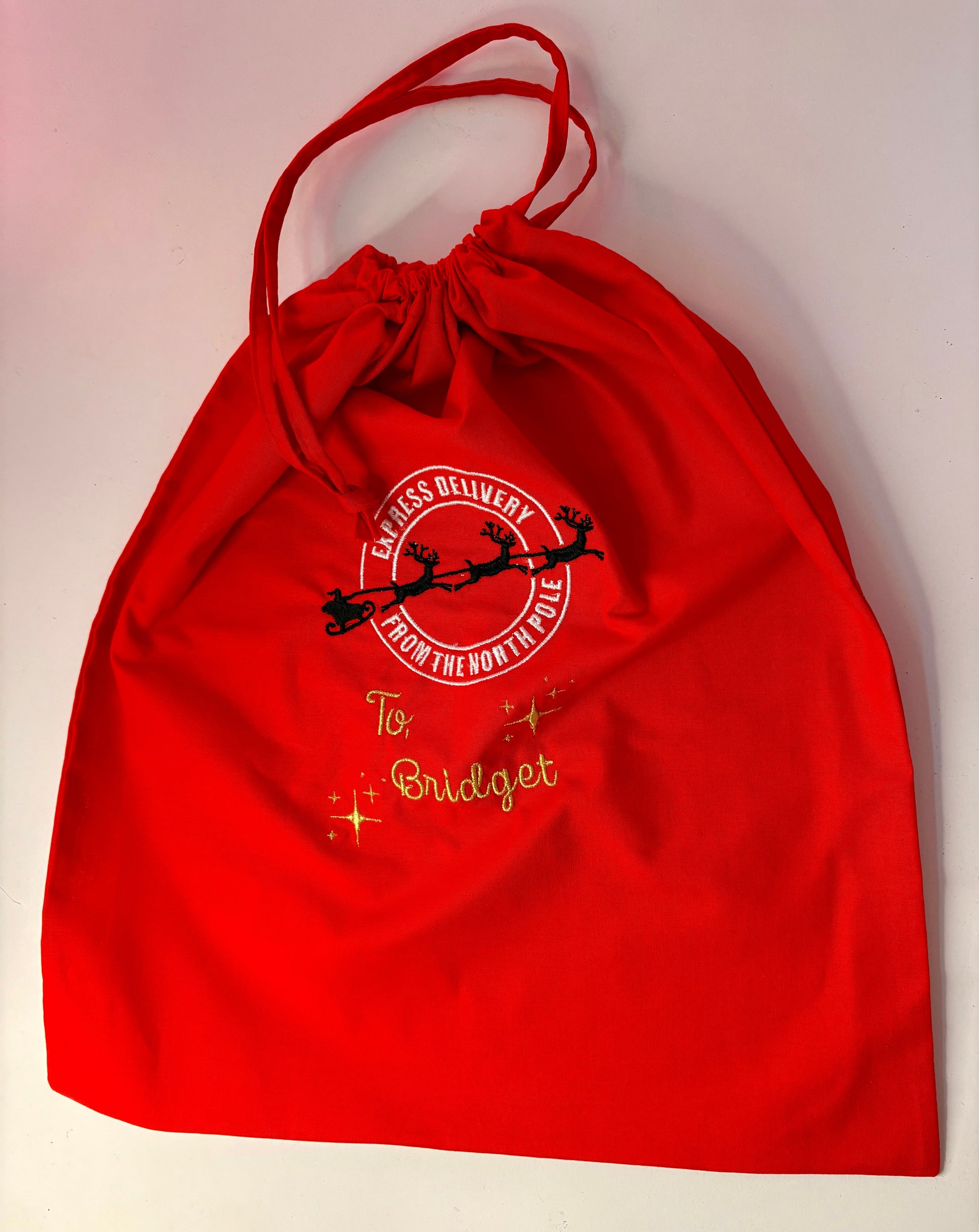 Red personalised embroidered Christmas sack with Special Delivery from the North Pole design and metallic gold name stitching