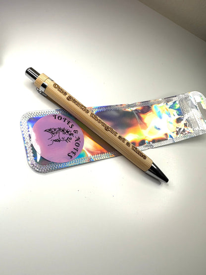 Eco-friendly engraved bamboo pen with "one gentle thought at a time" phrase and refill ink options in a holographic pouch