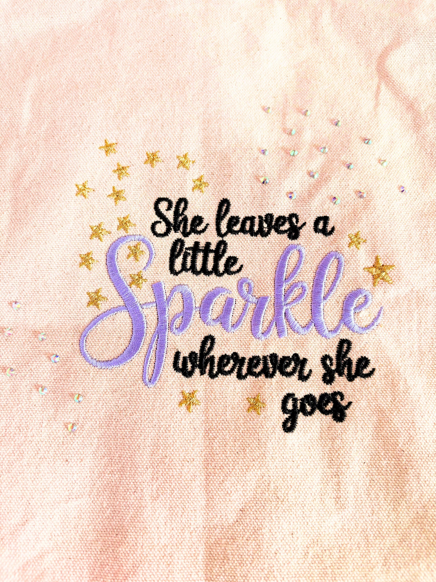 Embroidered canvas tote bag with "She Leaves a Little Sparkle Wherever She Goes" slogan and sparkling diamante embellishments