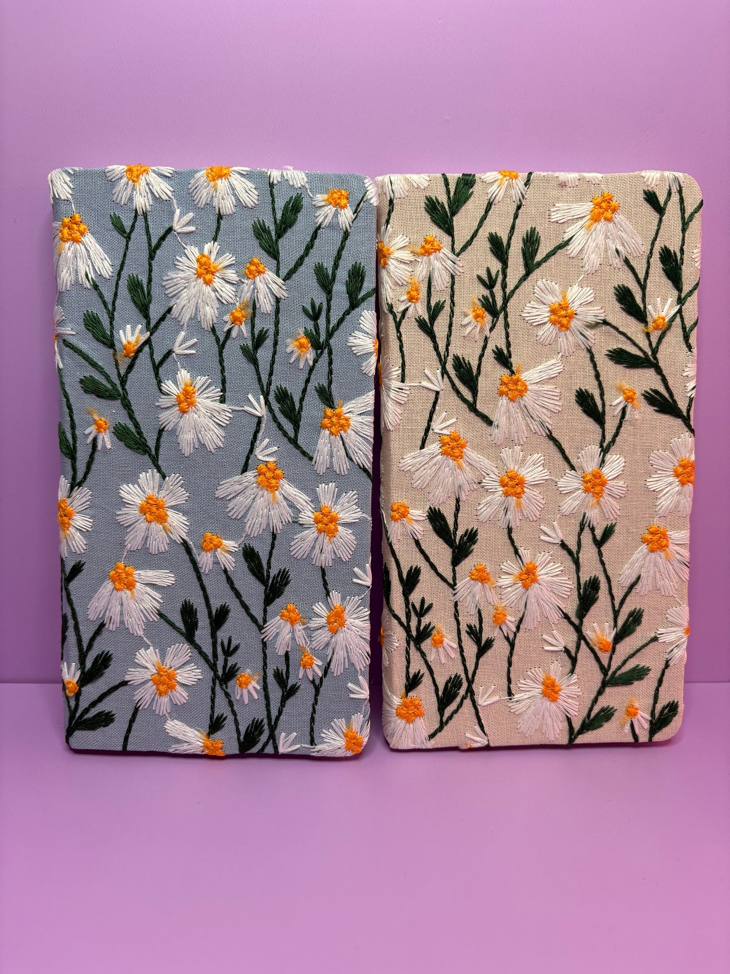 A6 handy notebooks with blue and cream hardback covers embroidered with delicate daisies
