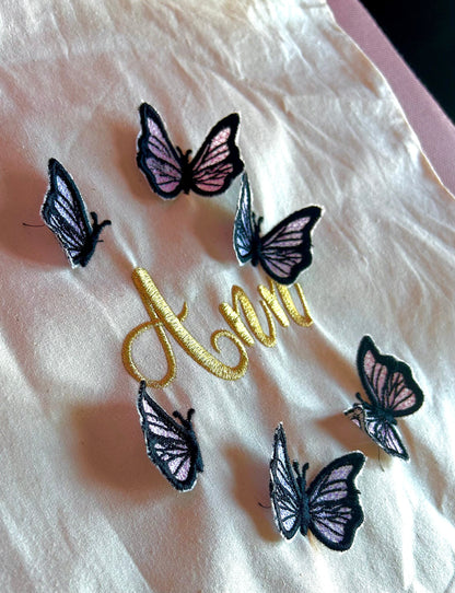Embroidered butterfly tote bag with personalized gold name.
