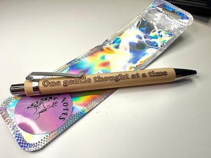 Eco-friendly engraved bamboo pen with the phrase "one gentle thought at a time" and refillable ink options