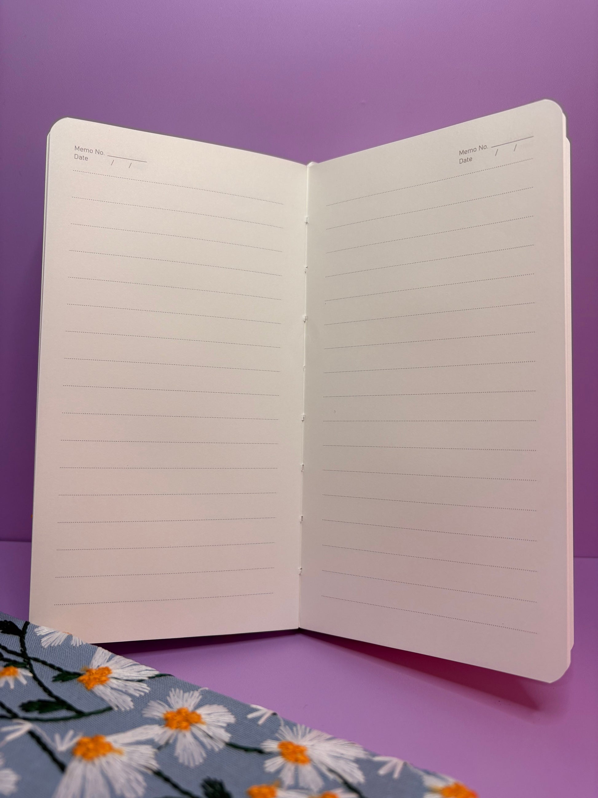 A6 Embroidered Daisy notebook with lined pages and floral hardback cover in blue or cream