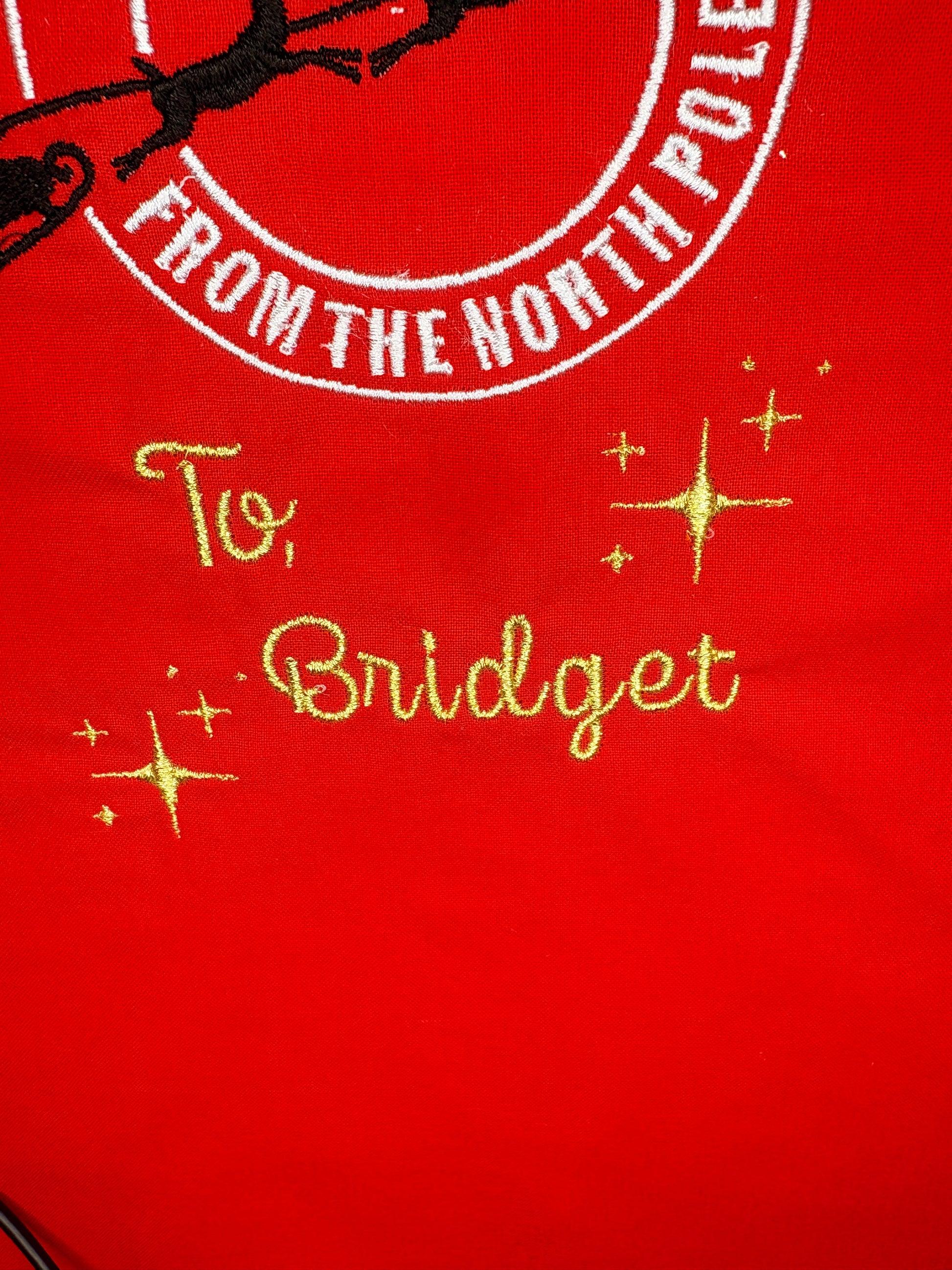 Personalised red Christmas sack with "Special Delivery from the North Pole" embroidery and gold name stitching "To, Bridget"