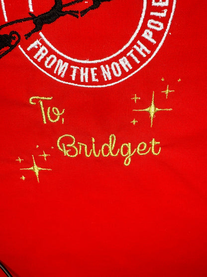 Personalised red Christmas sack with "Special Delivery from the North Pole" embroidery and gold name stitching "To, Bridget"