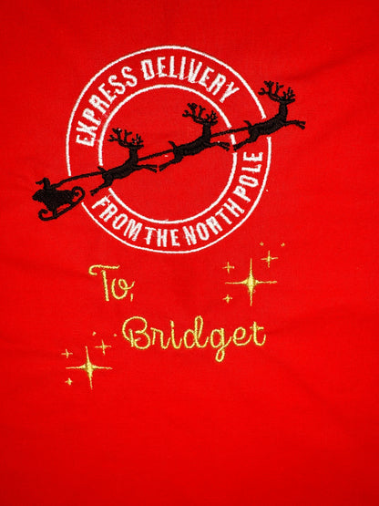Red personalised Christmas sack with gold embroidered "Special Delivery from the North Pole" and name "Bridget"