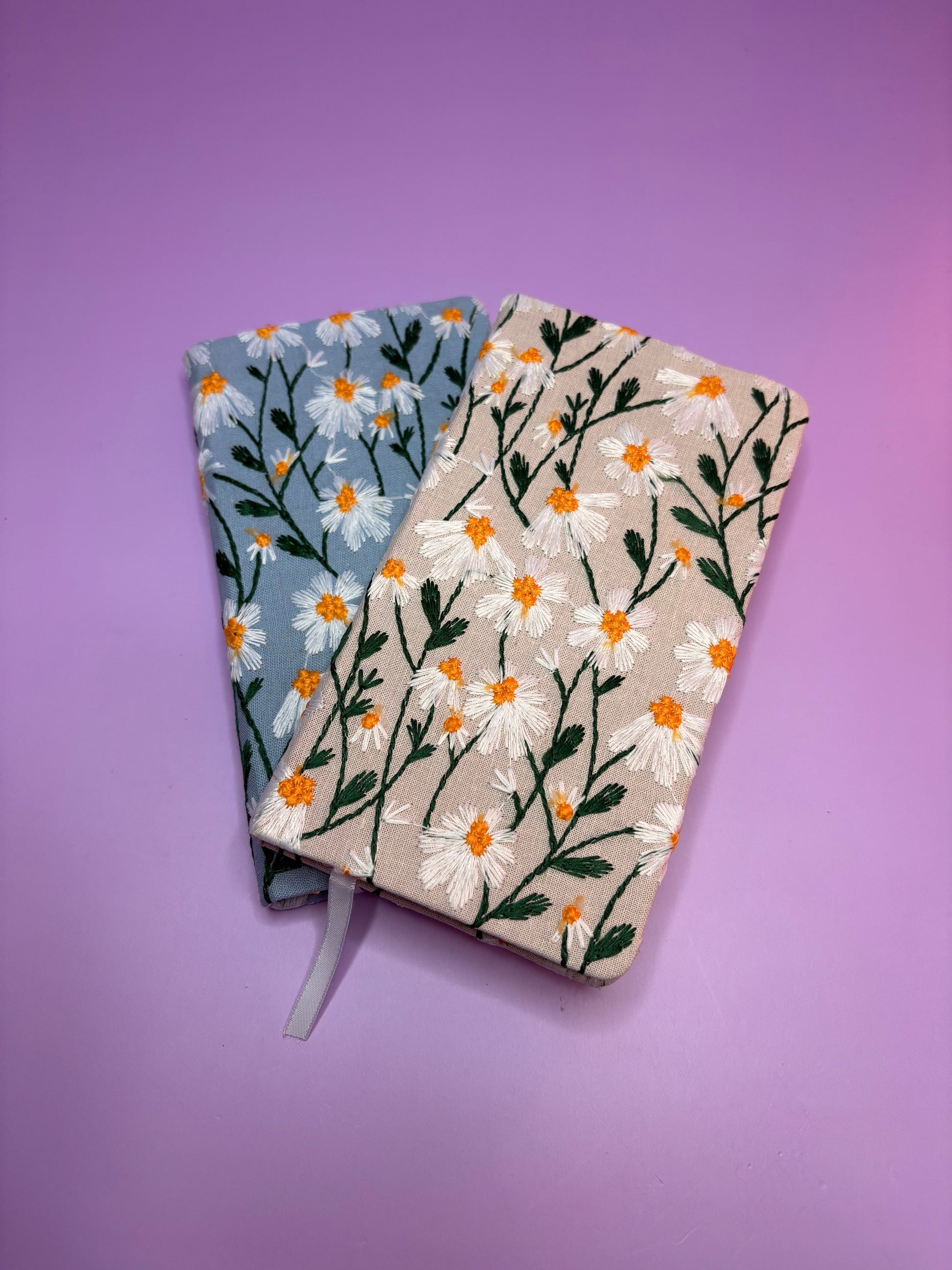 A6 embroidered daisy notebooks in blue and cream with hardback covers and floral design