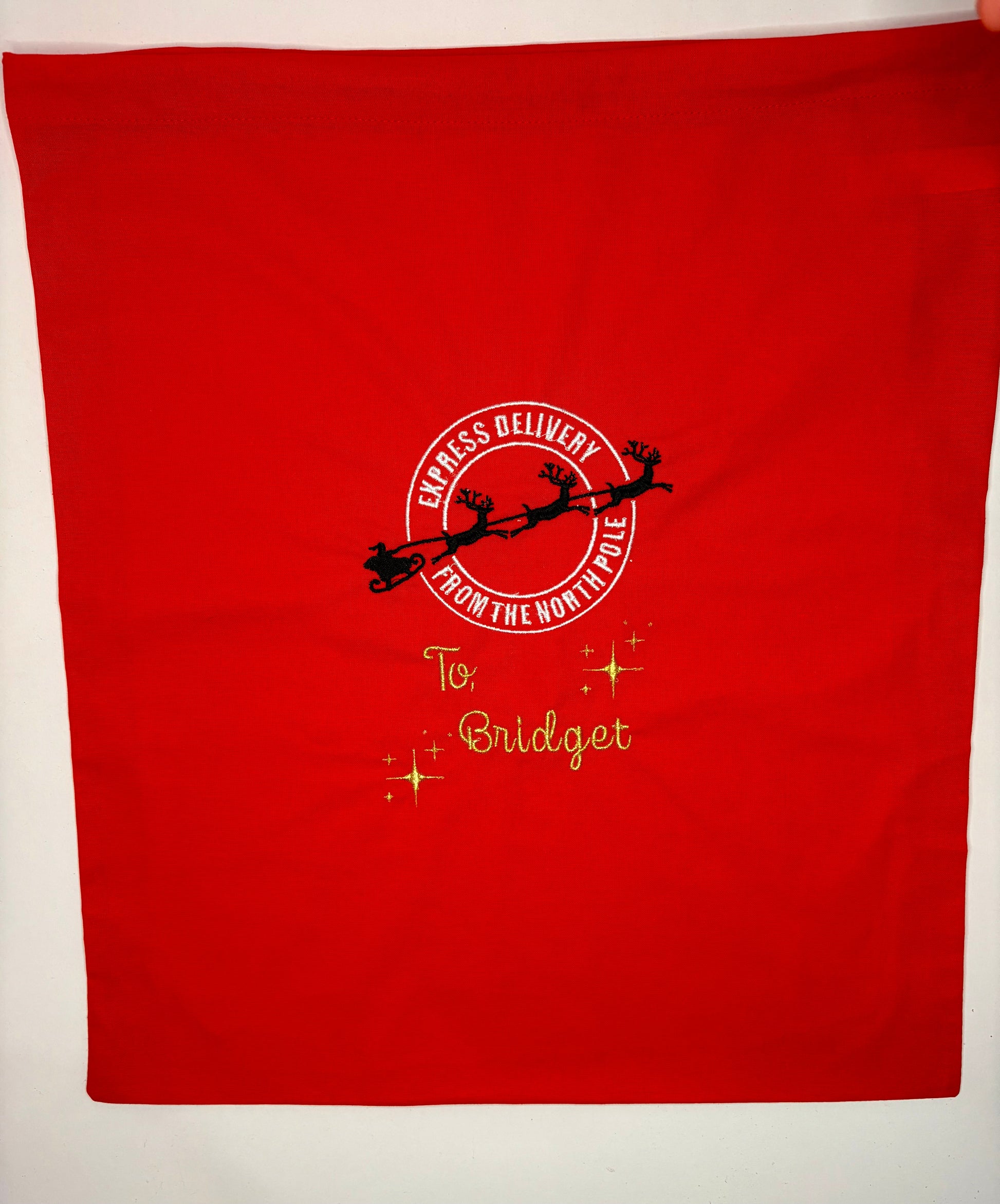 Red personalised Christmas sack with "Special Delivery from the North Pole" embroidery and metallic gold name "Bridget"