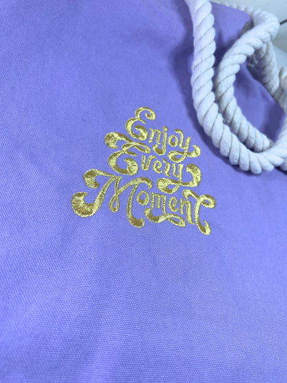Lilac marine style tote bag with gold "Enjoy Every Moment" embroidery and thick white rope handles