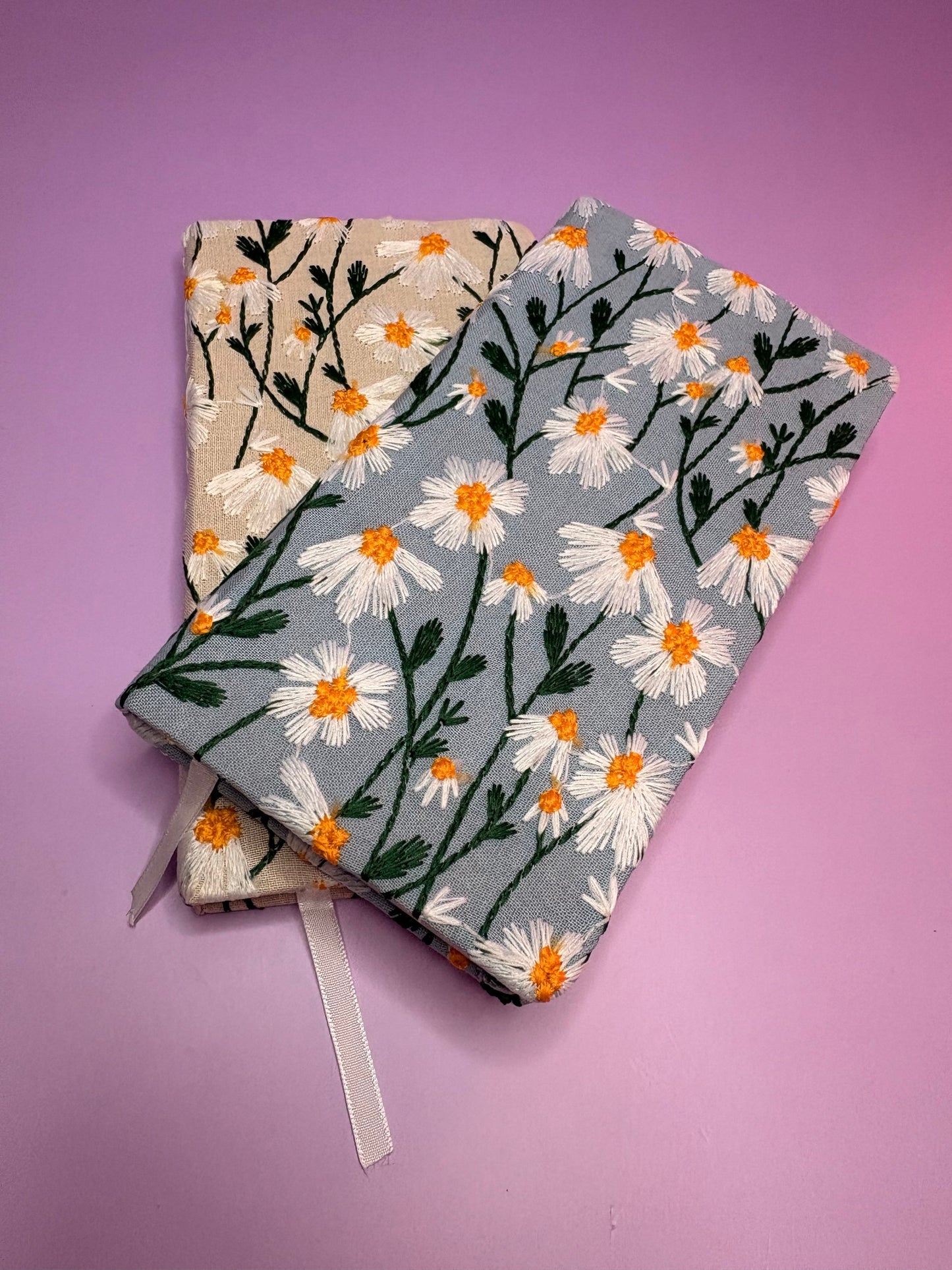 A6 embroidered daisy hardback notebooks in blue and cream with floral design on lined pages