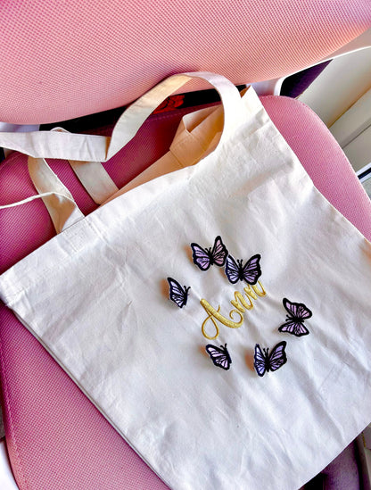 Embroidery tote bag with butterfly design and customizable name in gold thread, perfect personalised gift.