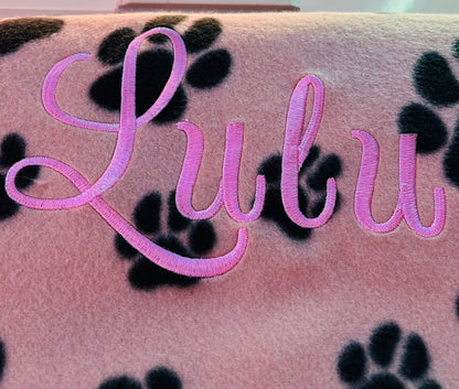 personalised dog blanket with name embroidery and paw print pattern