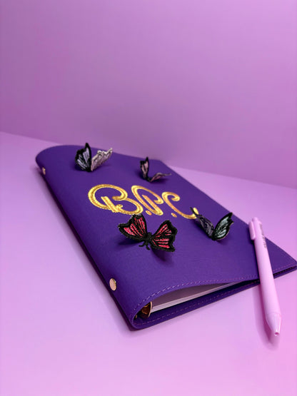 Purple A5 fabric file with personalised 3D butterfly embroidery and pen on purple background