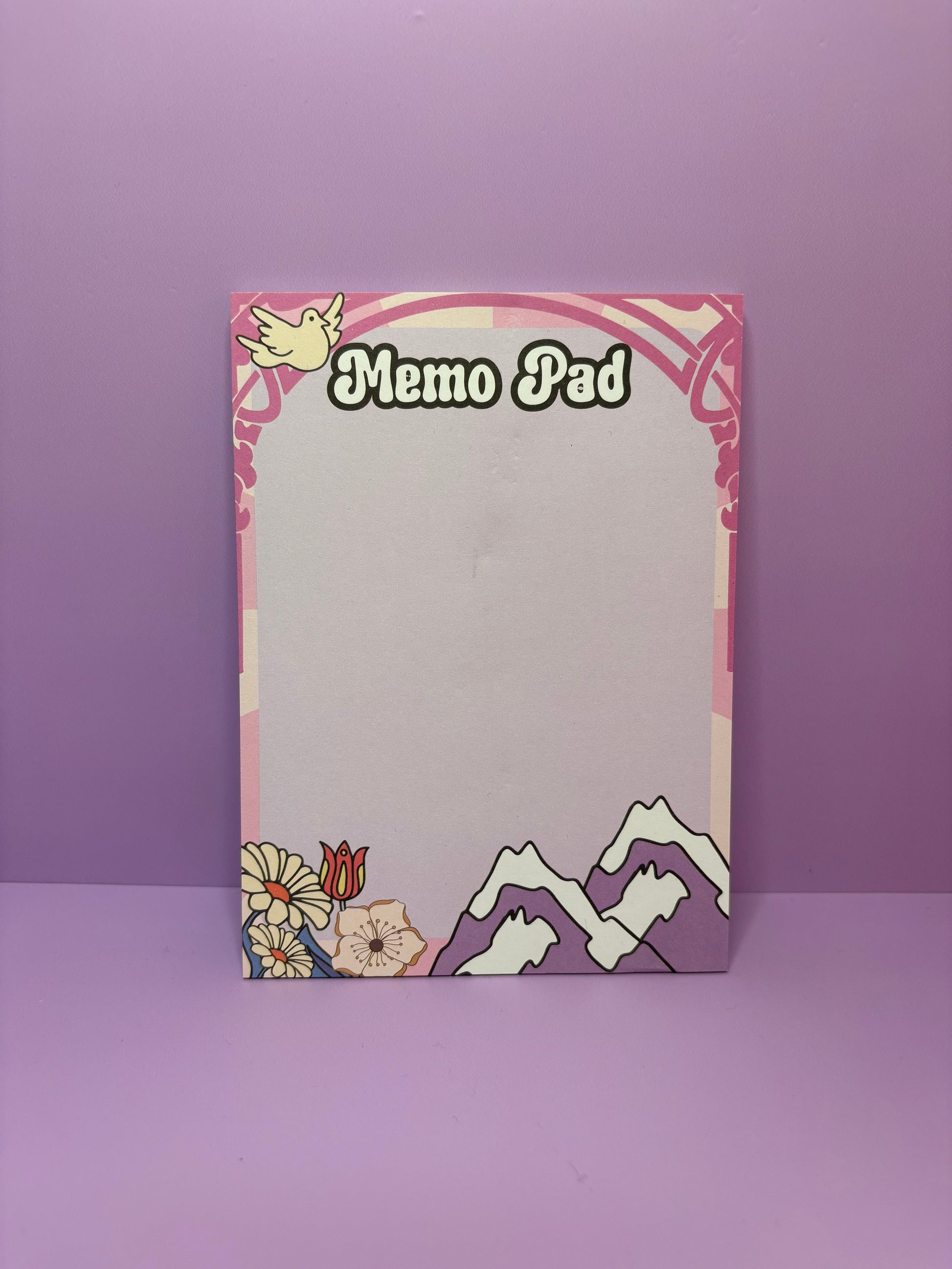 Breathe & Bloom A6 memo pad with retro 70s floral and mountain design on lilac background