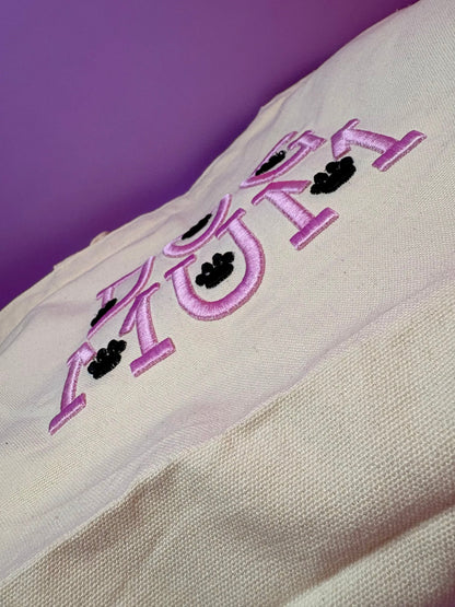 Close-up of Dog Mum 3D puff embroidered text on heavy canvas tote bag against purple background