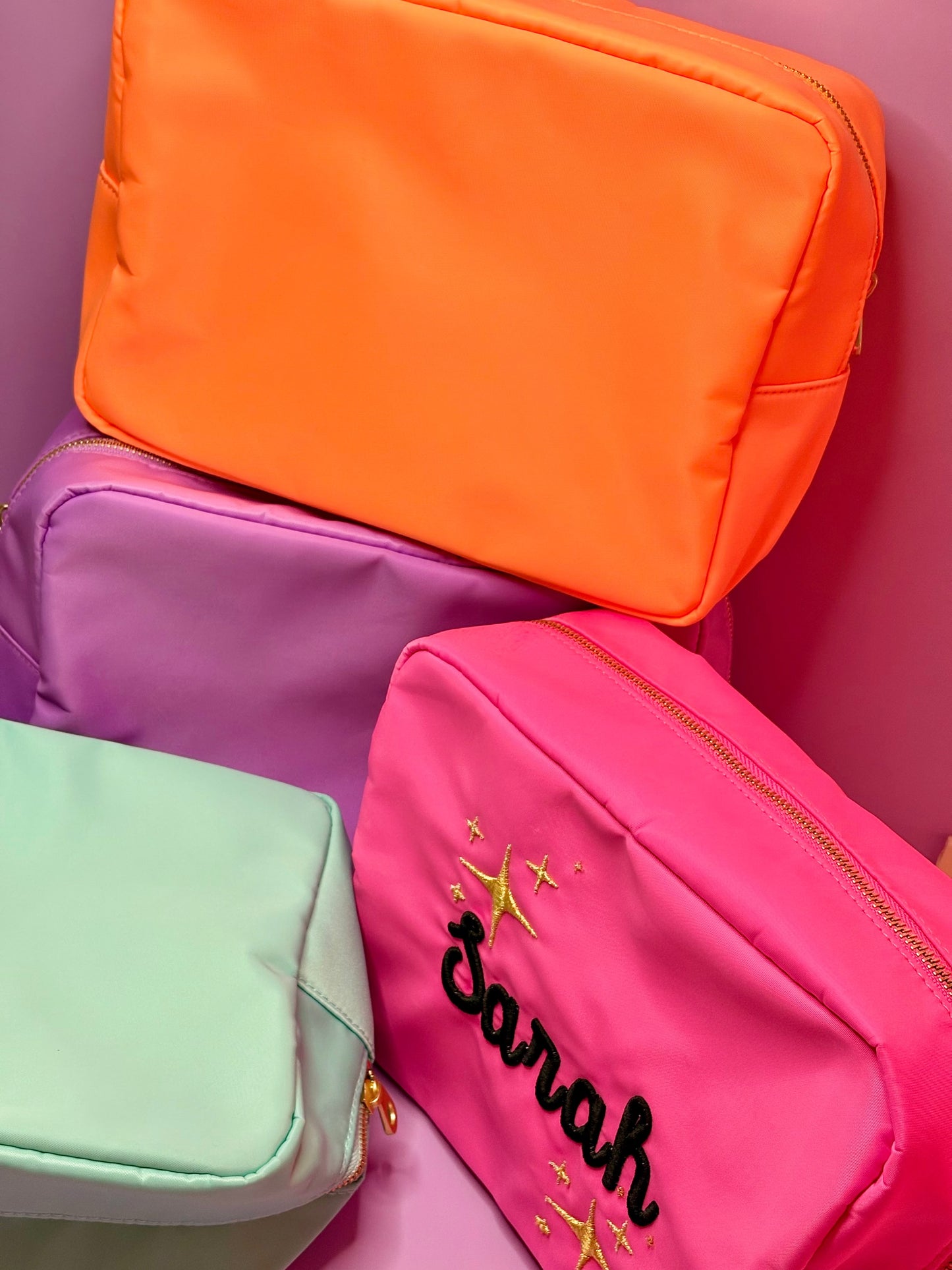 Personalised 3D puff embroidered large cosmetic bags in vibrant colors including hot pink, licious lilac, cool mint, and sorbet orange with custom name embroidery.
