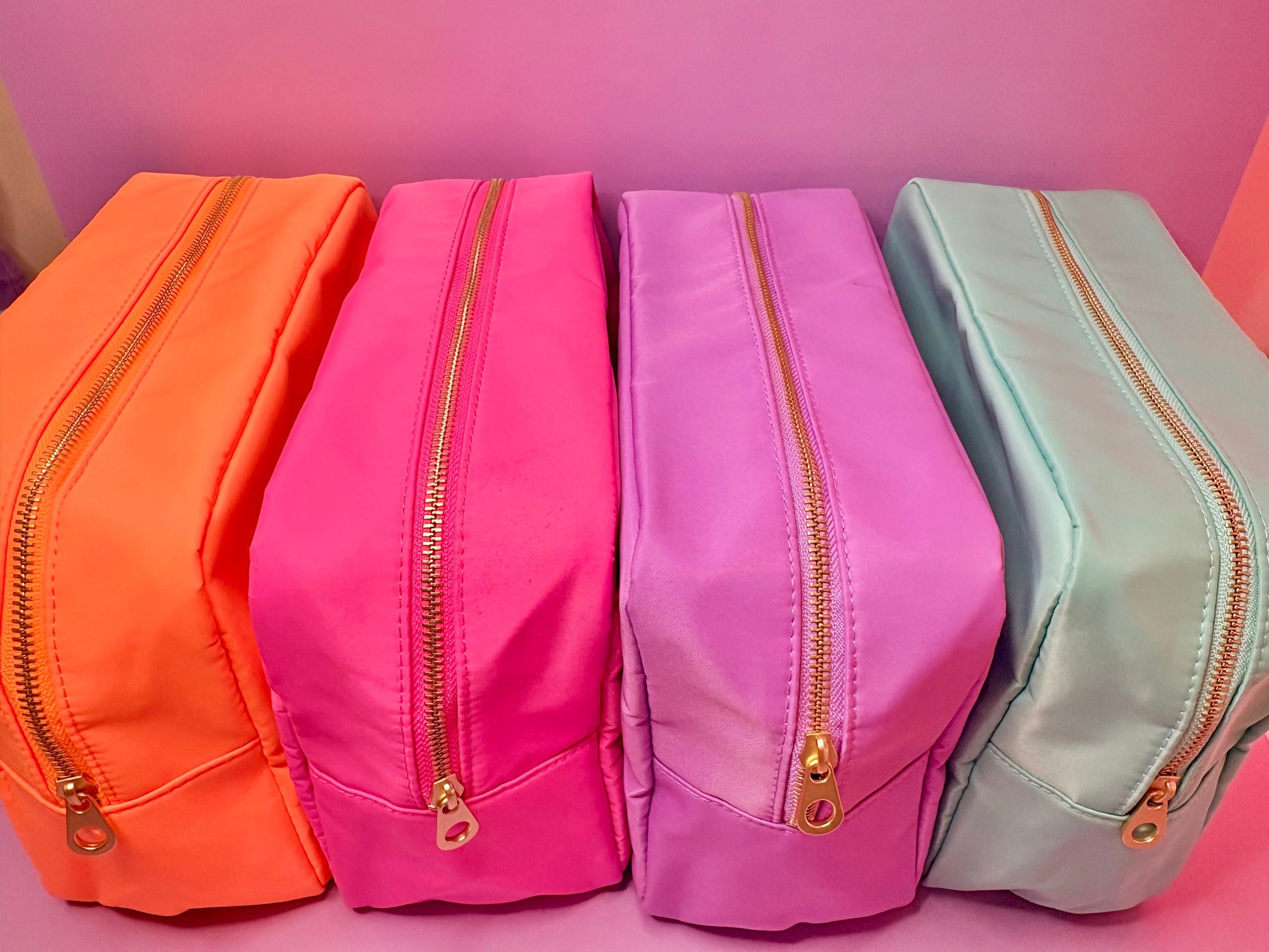 Personalised 3D puff embroidered large cosmetic bags in hot pink, licious lilac, cool mint, and sorbet orange with gold zippers.