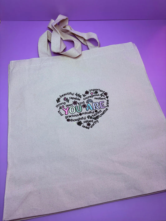 Uplifting Reminder Embroidered Canvas Tote Bag with motivational text and long handles on durable canvas