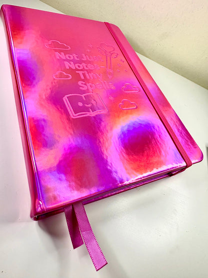 A5 Tiny Spells Notebook with holographic PU leather cover, laser-edged pages, two pink ribbon markers, and back pocket for notes