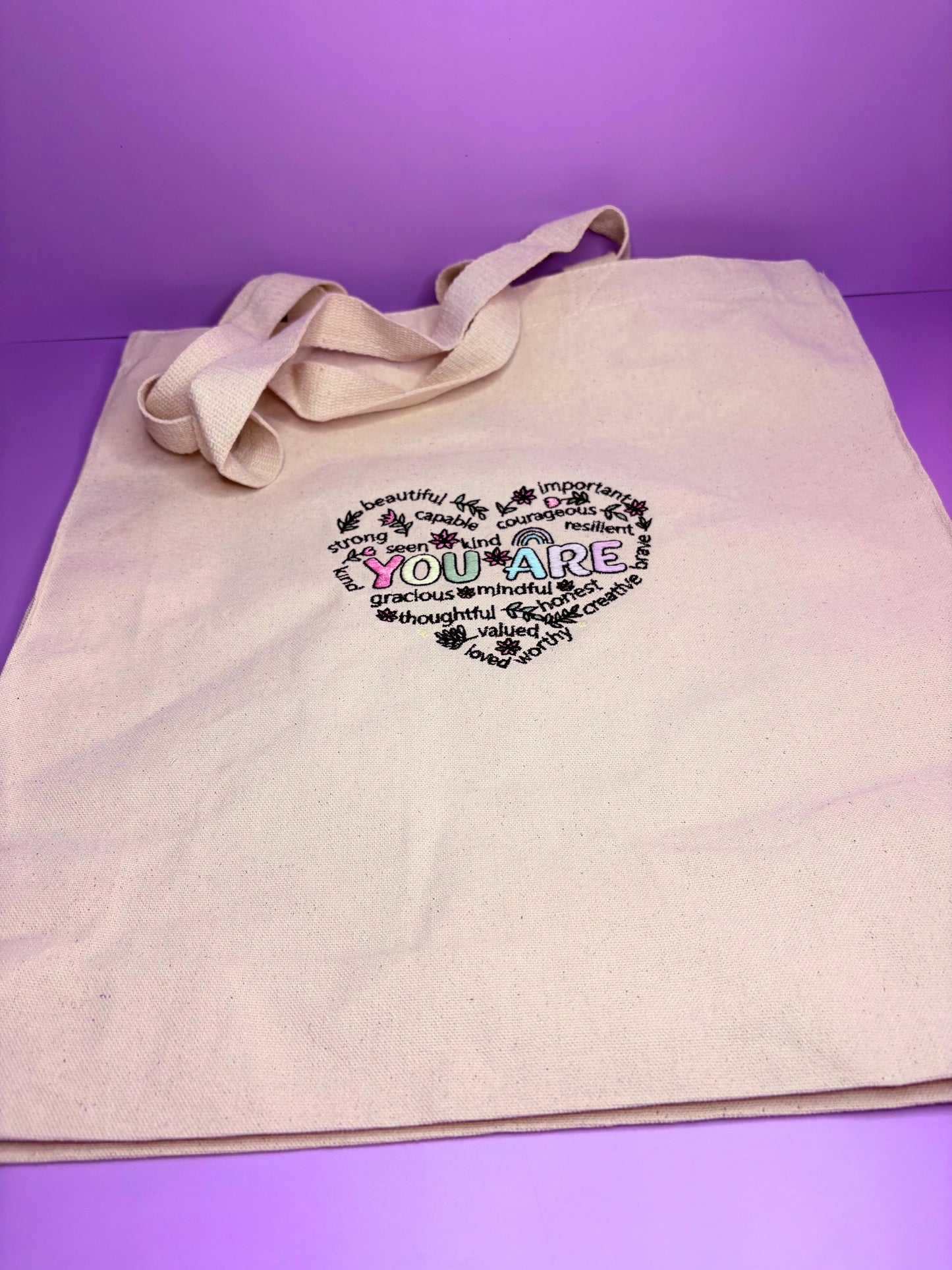 Uplifting reminder embroidered canvas tote bag with long handles and gusseted base for everyday use and gifting