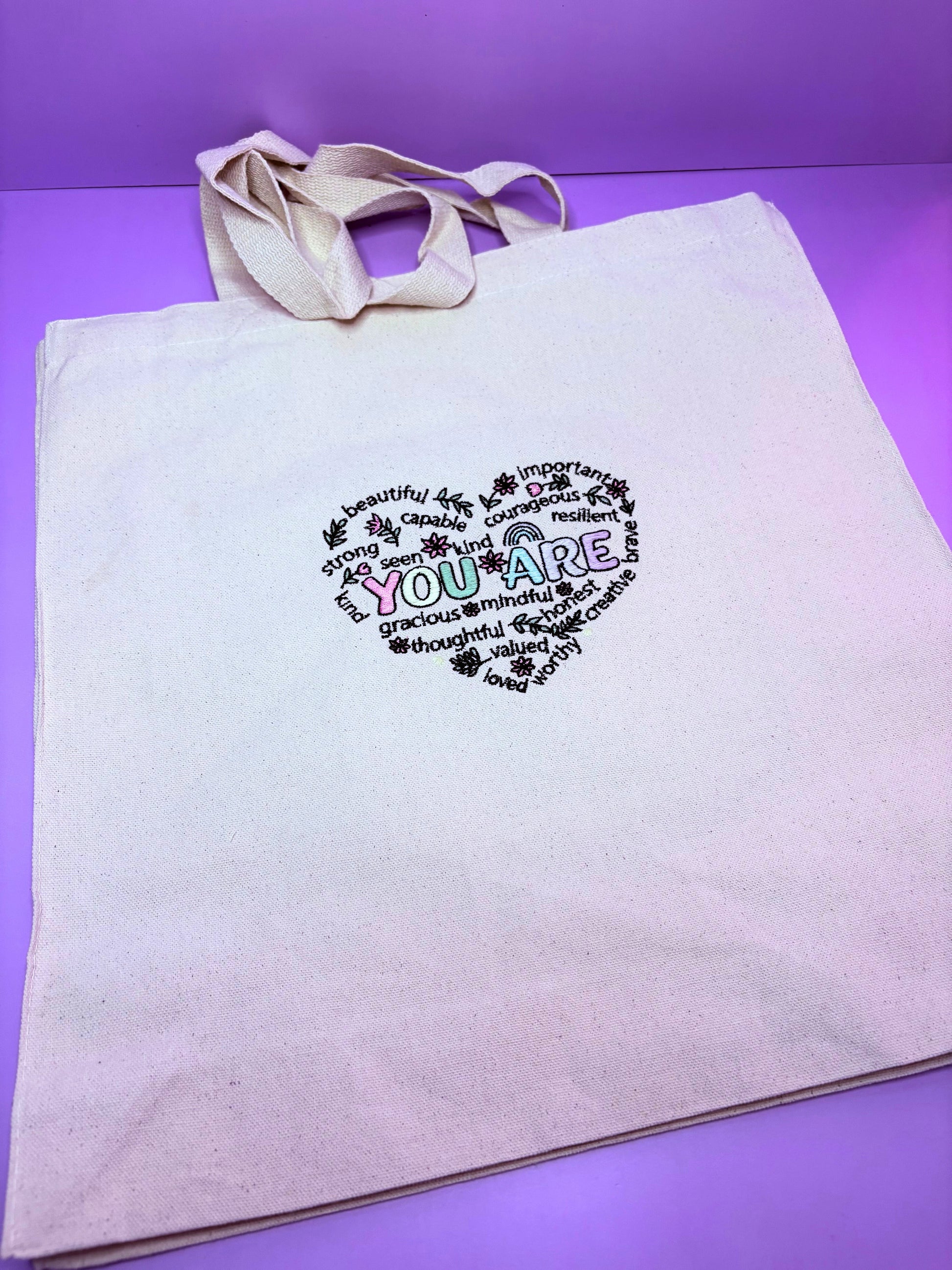 Uplifting Reminder Embroidered Canvas Tote Bag with durable gusseted design and long handles for everyday use and gifting