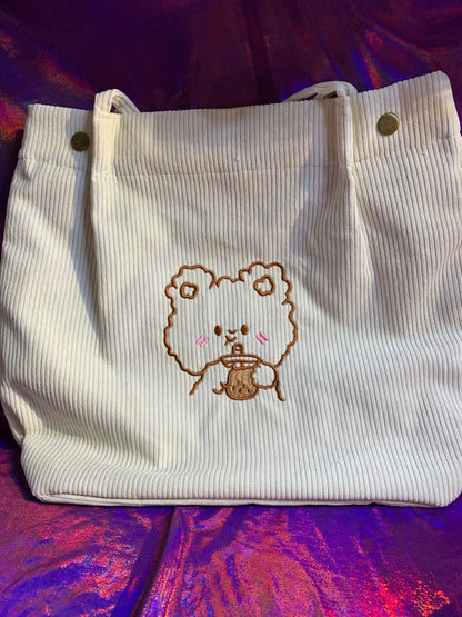 A kawaii style tote bag featuring an embroidered bear with boba, in cute pink and white corduroy, waterproof for shopping needs.